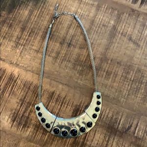 Gold necklace with black pearl-like design